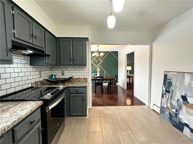 kitchen featuring decorative light fixtures, tasteful backsplash, a baseboard heating unit, range with electric cooktop, and light stone countertops