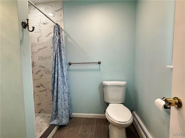 bathroom with toilet, baseboard heating, and a shower with curtain