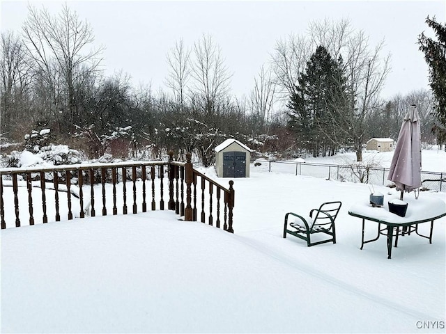 yard covered in snow with a shed