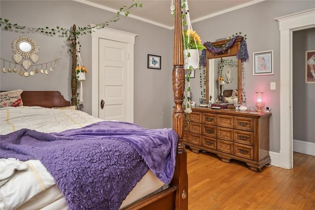 bedroom with crown molding and hardwood / wood-style flooring