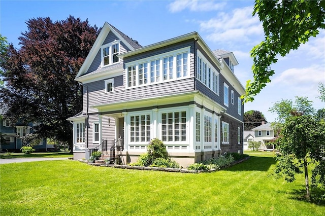 rear view of property with a yard