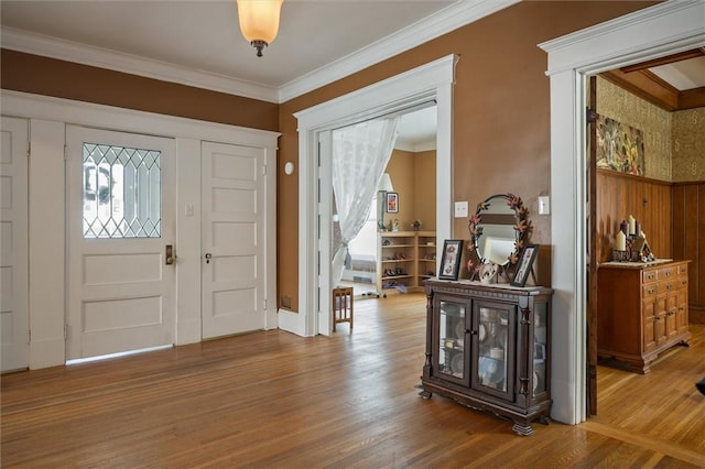 entrance foyer featuring light hardwood / wood-style flooring and crown molding