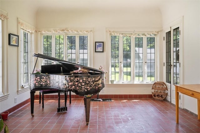 misc room featuring tile patterned flooring and a wealth of natural light