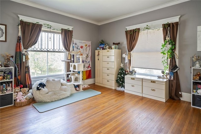 sitting room with light wood-type flooring and ornamental molding