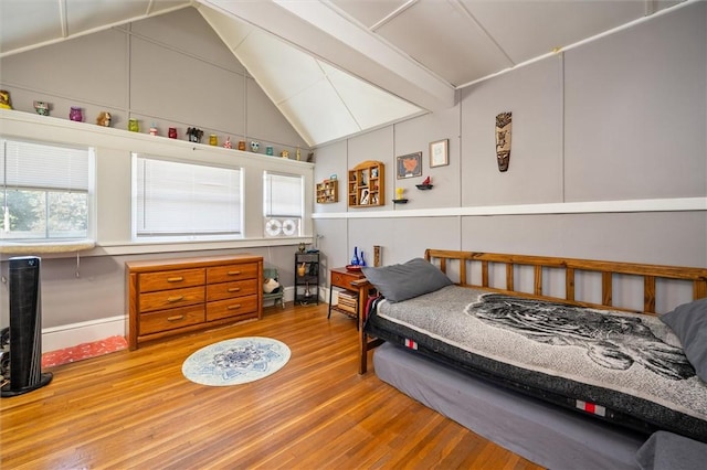 bedroom with wood-type flooring and lofted ceiling