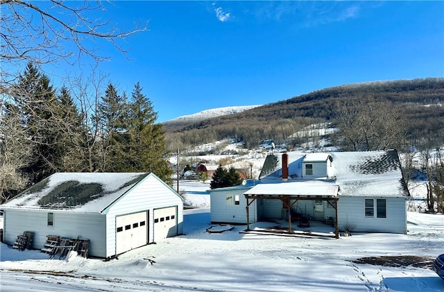 exterior space featuring a garage and a mountain view