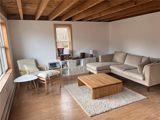 living room with light wood-type flooring, beam ceiling, baseboard heating, and wood ceiling