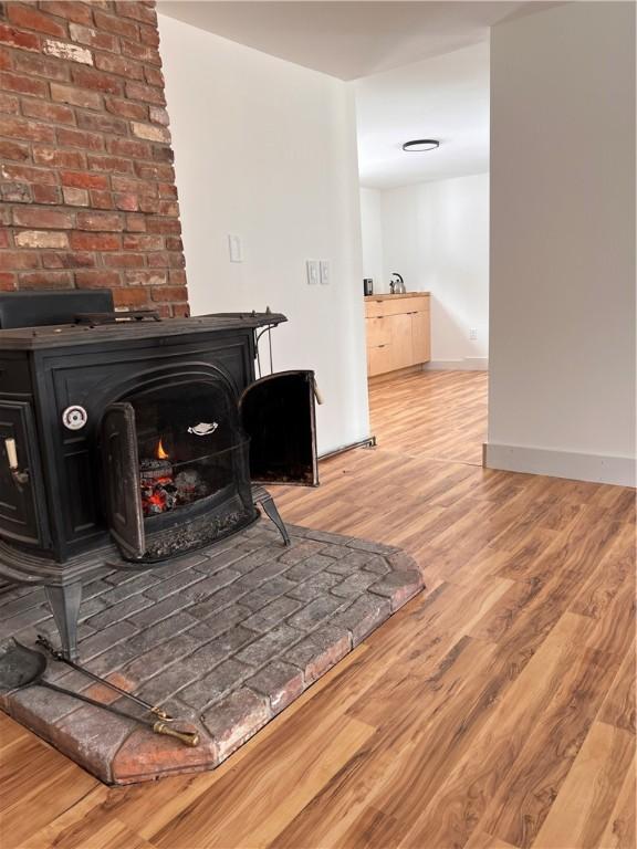 room details featuring a wood stove and hardwood / wood-style floors