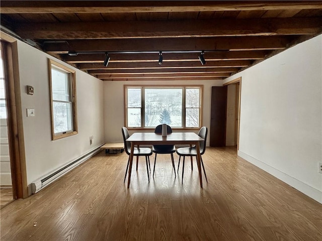 dining space with beam ceiling, a baseboard heating unit, wood ceiling, and hardwood / wood-style floors