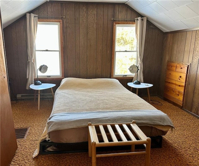 carpeted bedroom featuring baseboard heating, vaulted ceiling, and wood walls