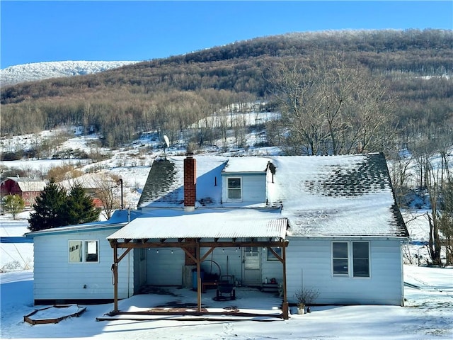 snow covered house with a mountain view