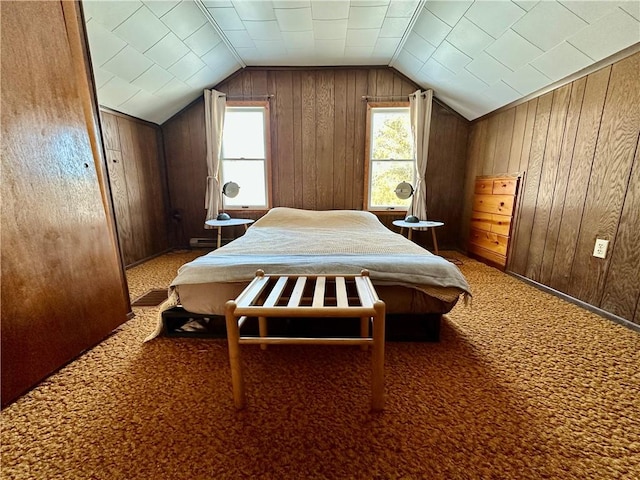 bedroom with carpet floors, vaulted ceiling, and wood walls