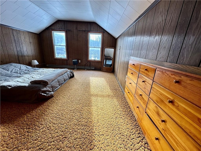 carpeted bedroom featuring a baseboard heating unit, wooden walls, and vaulted ceiling