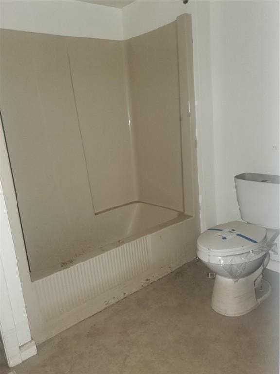 bathroom with toilet, plus walk in shower, and concrete flooring