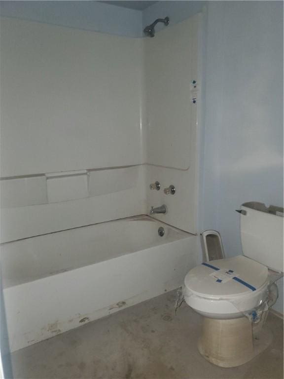 bathroom with toilet and bathing tub / shower combination