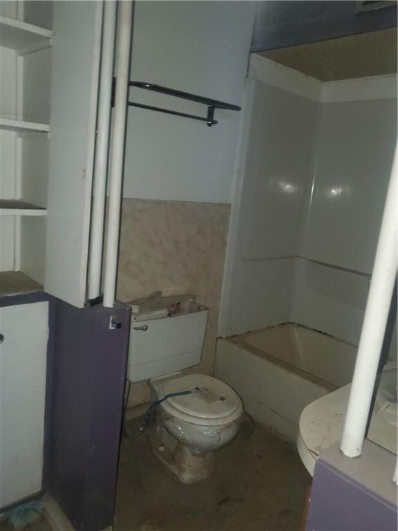 bathroom with bathing tub / shower combination and toilet