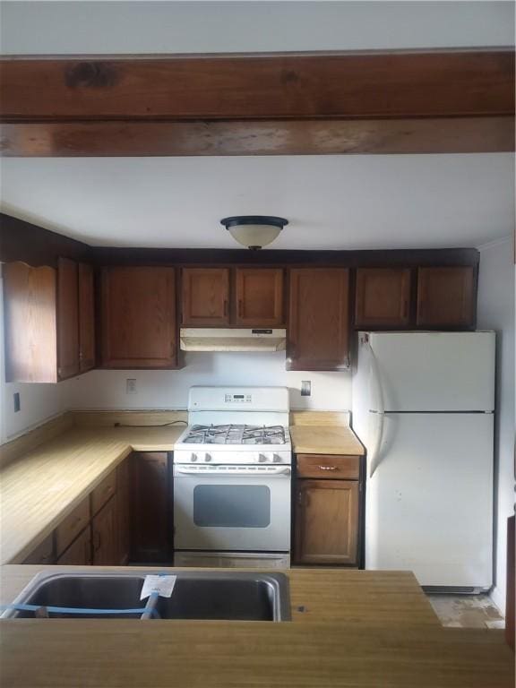 kitchen featuring sink and white appliances