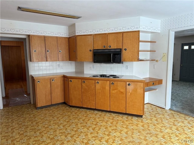 kitchen with white electric cooktop and tasteful backsplash