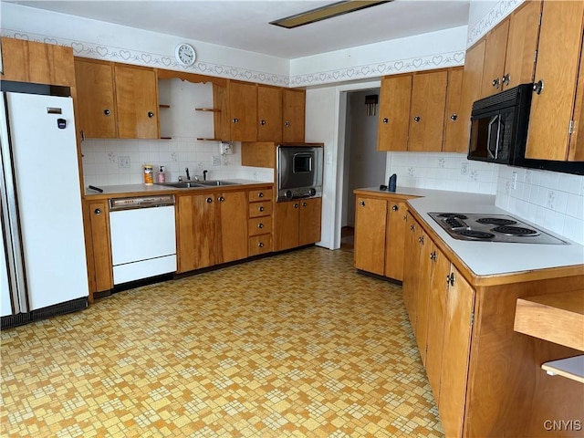 kitchen featuring decorative backsplash, sink, and black appliances