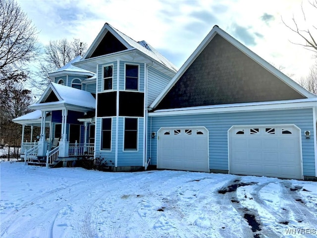 view of front facade featuring covered porch and a garage