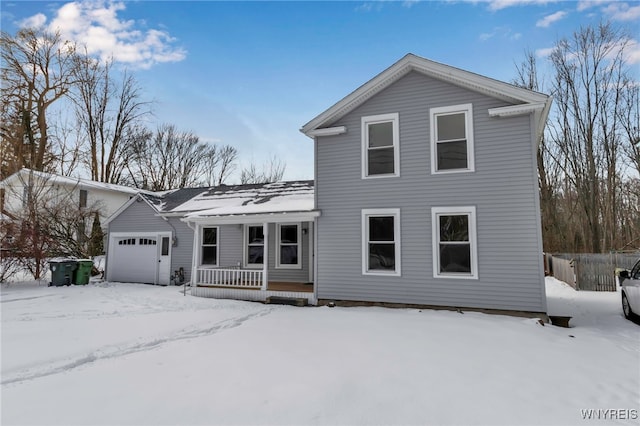 view of property with a garage and covered porch