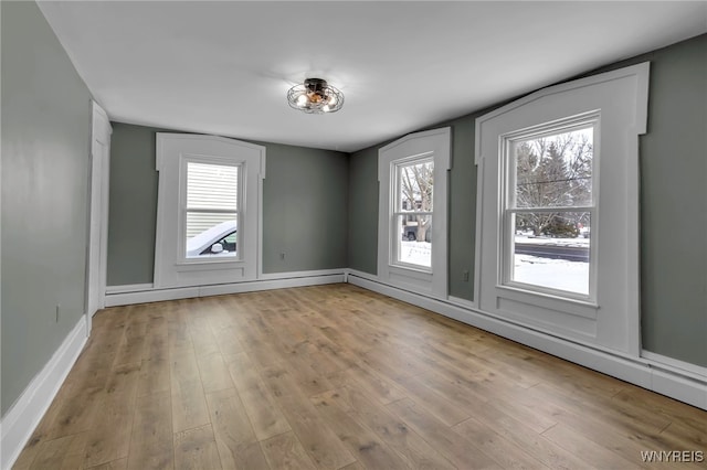 unfurnished room with light wood-type flooring