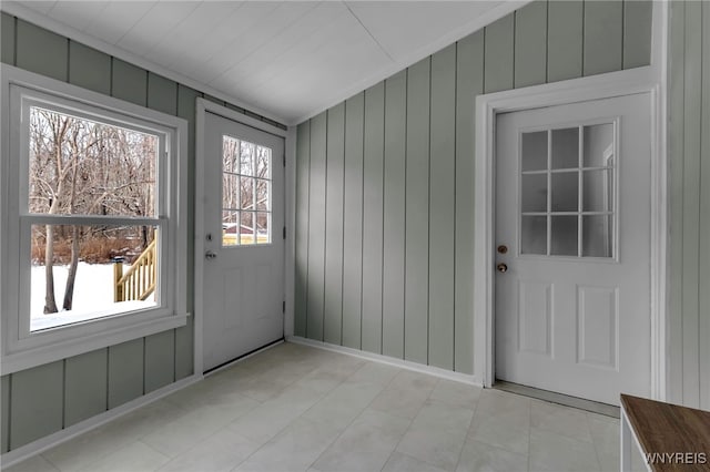 doorway to outside featuring wooden walls