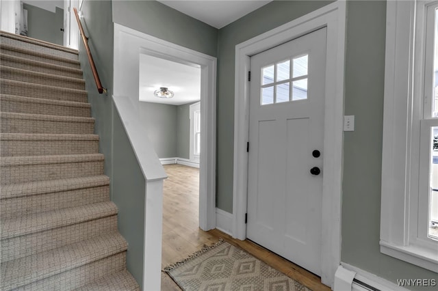 foyer with light hardwood / wood-style floors and a baseboard heating unit