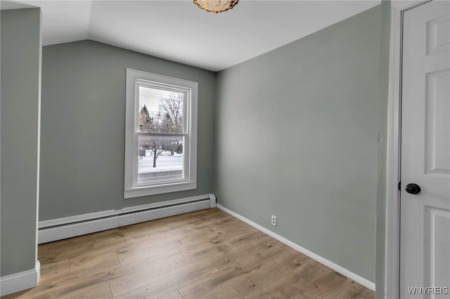 unfurnished room featuring light hardwood / wood-style floors, a baseboard radiator, and lofted ceiling