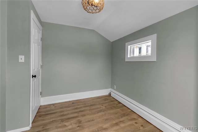 bonus room with baseboard heating, lofted ceiling, and hardwood / wood-style floors