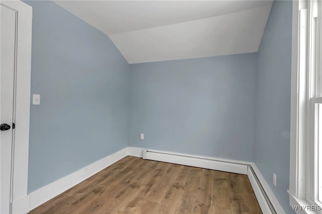 bonus room featuring hardwood / wood-style flooring, a baseboard radiator, and vaulted ceiling