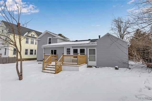 snow covered property with a deck