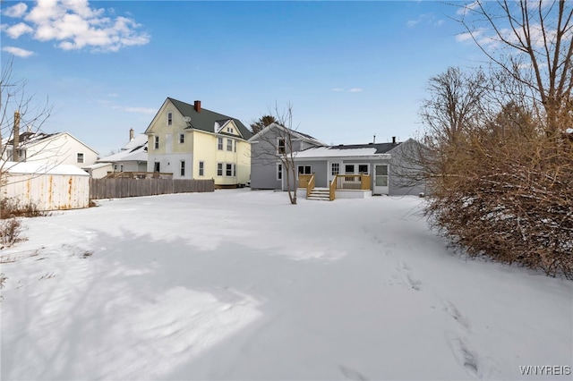 snow covered property featuring solar panels