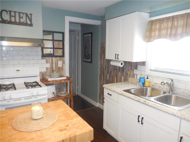 kitchen featuring sink, white cabinetry, white range with gas cooktop, and range hood