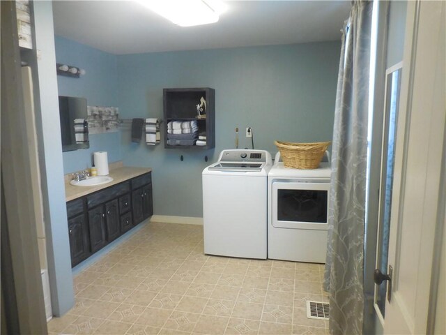 washroom featuring separate washer and dryer and sink