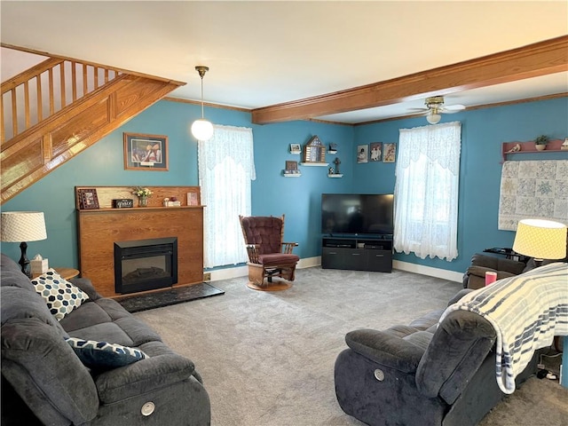 carpeted living room featuring ceiling fan and ornamental molding