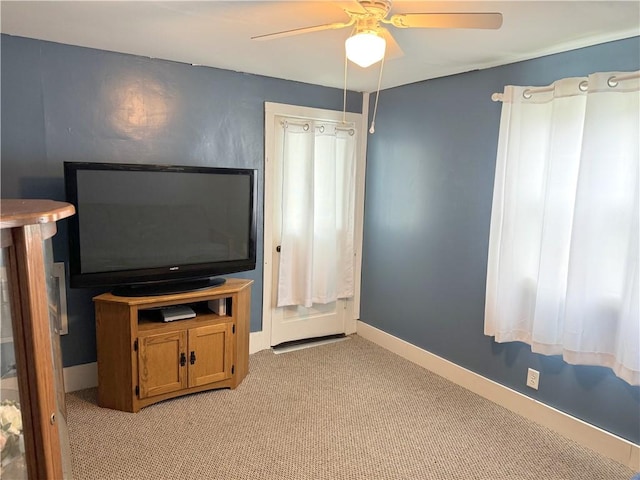 carpeted living room with ceiling fan