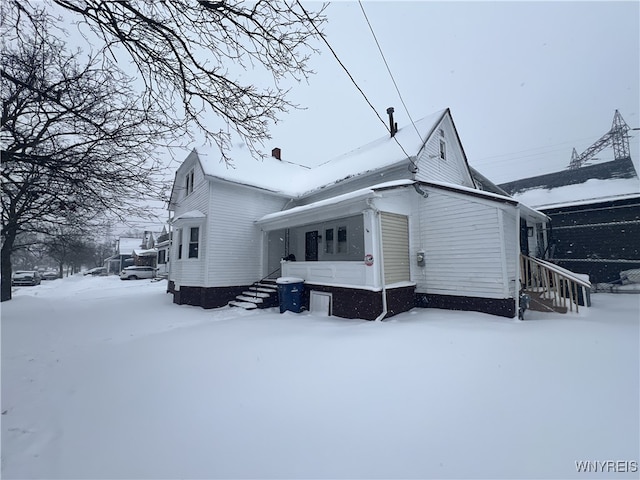 view of snowy exterior with a porch