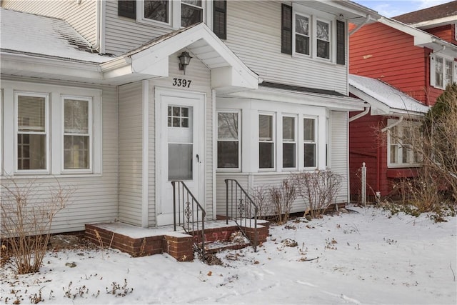 view of snow covered property entrance