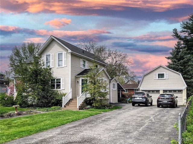 front of property with a garage and a yard