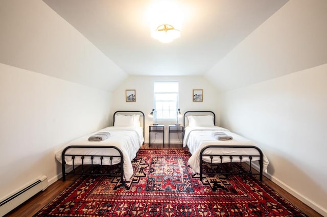 bedroom featuring lofted ceiling, a baseboard heating unit, and dark hardwood / wood-style floors