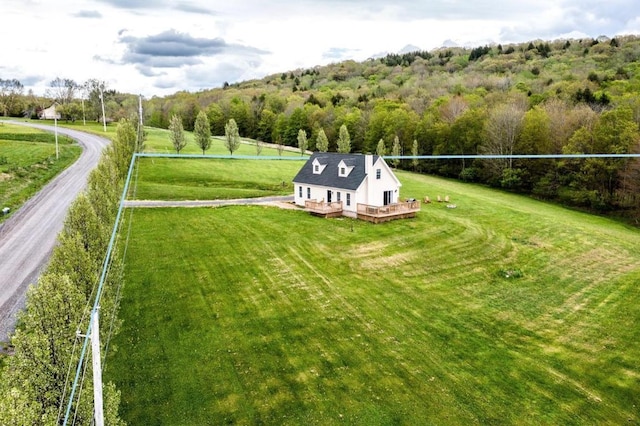 surrounding community with a deck and a yard