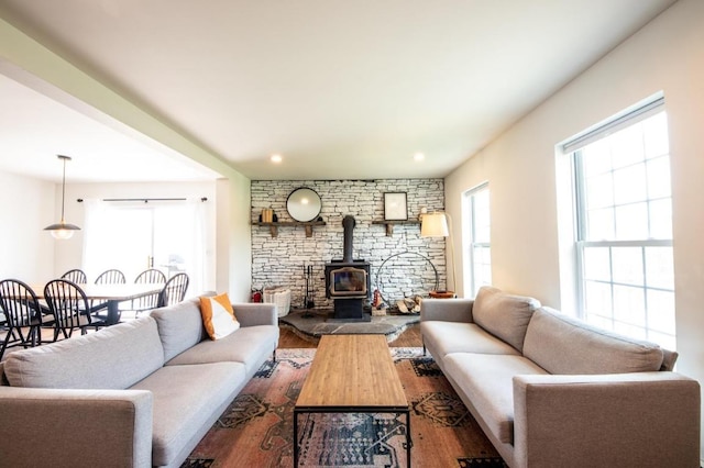 living room with a wood stove and hardwood / wood-style flooring