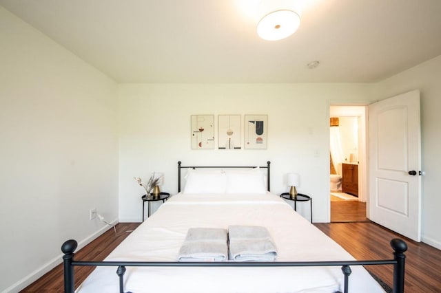 bedroom featuring dark wood-type flooring and connected bathroom