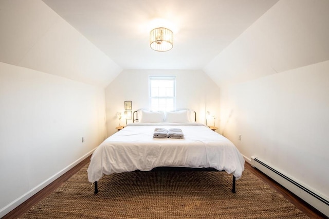 bedroom with lofted ceiling, wood-type flooring, and a baseboard radiator