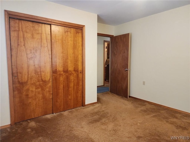 unfurnished bedroom with a closet and carpet