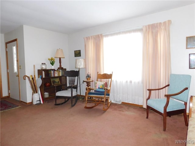 living area with a wealth of natural light and carpet floors