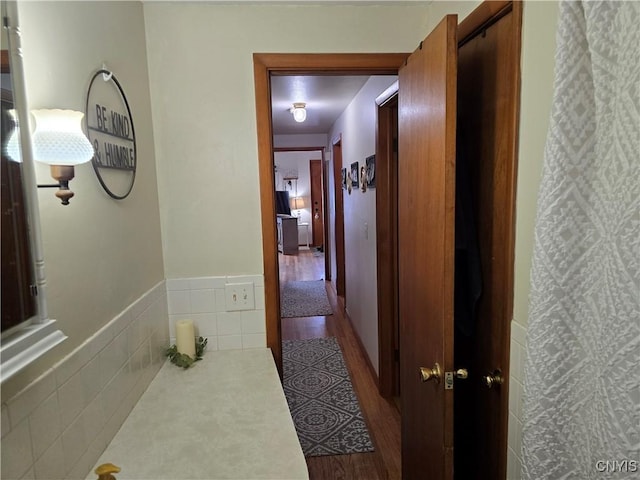 hallway featuring tile walls