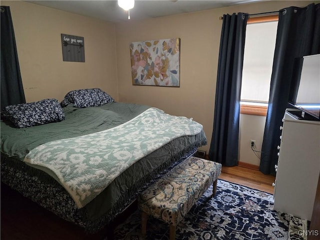 bedroom with hardwood / wood-style floors