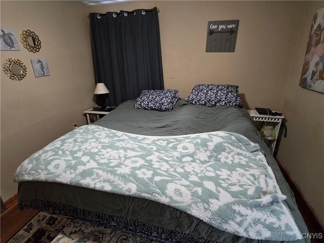 bedroom with hardwood / wood-style floors